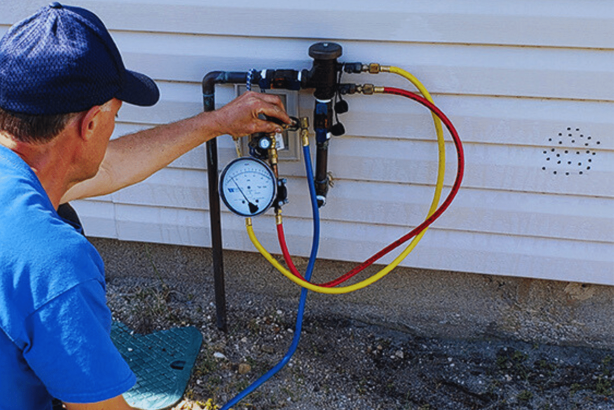 Isley plumber performing a backflow test on a home's water system