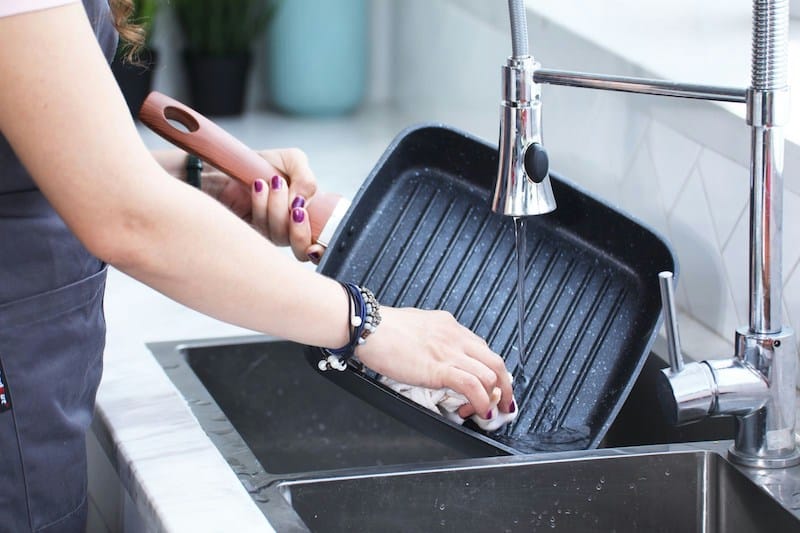 Kitchen sink with garbage disposal being used