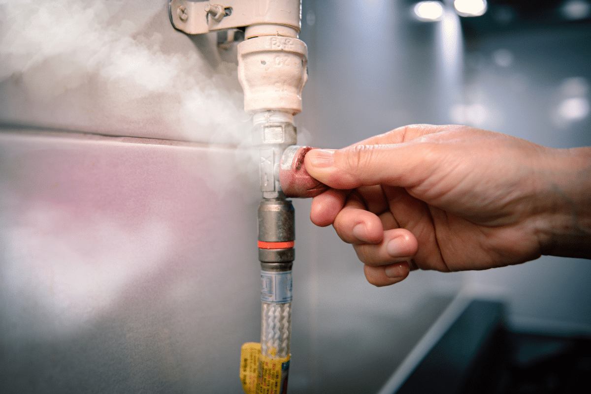 Technician checking a gas line for leaks
